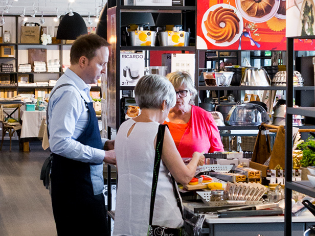 A RICARDO boutique adviser helping customers choose kitchen products